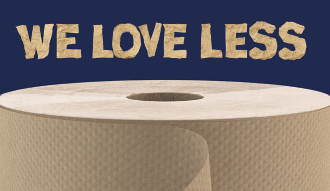 Hand roll towel beneath textured paper-cutout text reading “WE LOVE LESS”